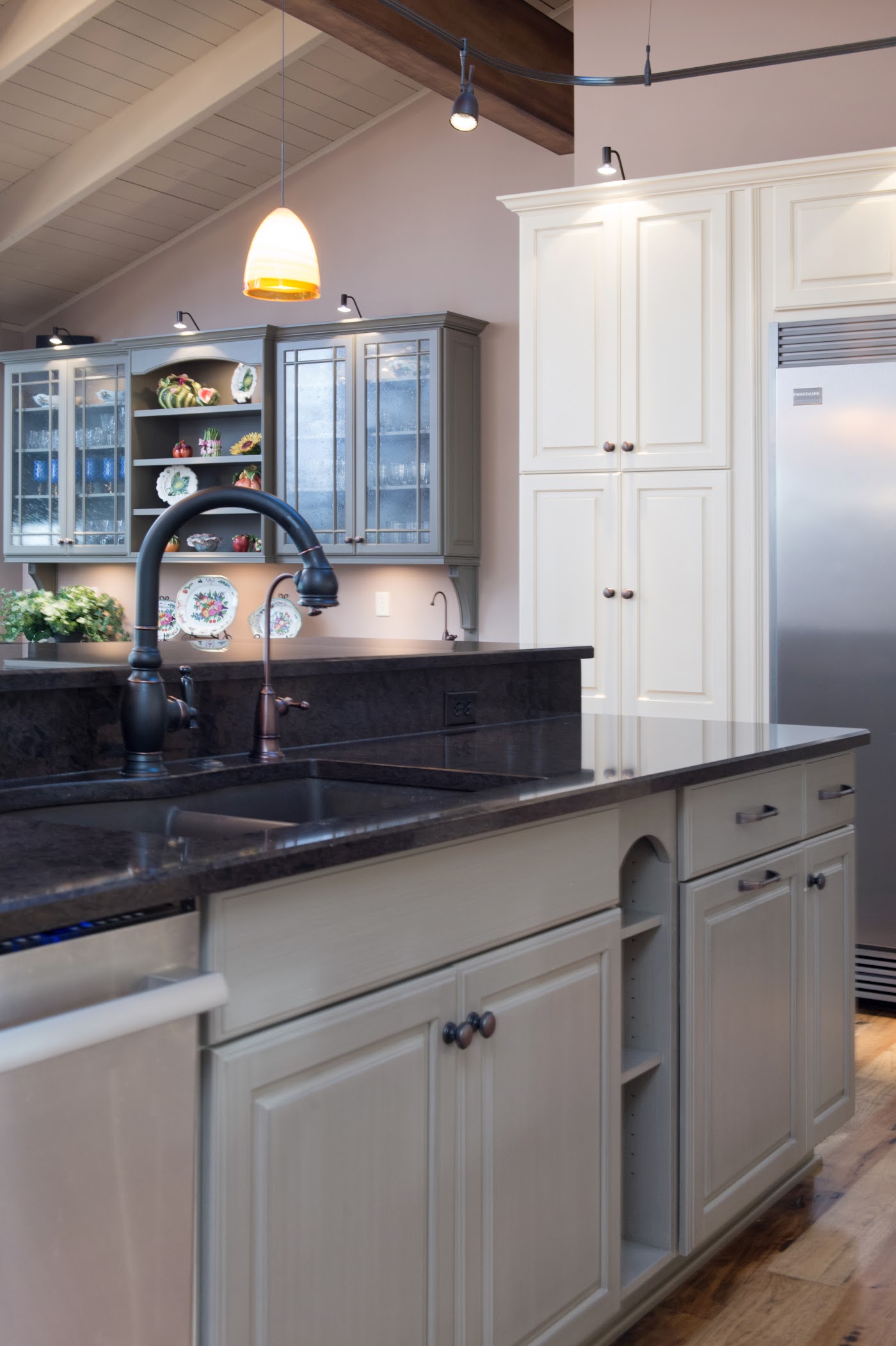 Kitchen with white cabinetry, a vaulted wood ceiling, and dark stone counters by Armstrong Kitchens